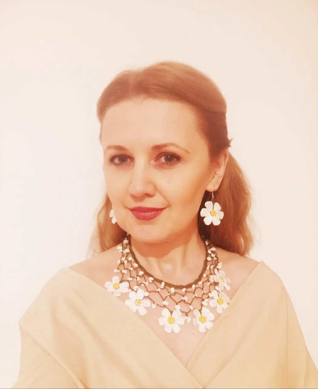 Portrait of Alina Chercea wearing white flower earrings